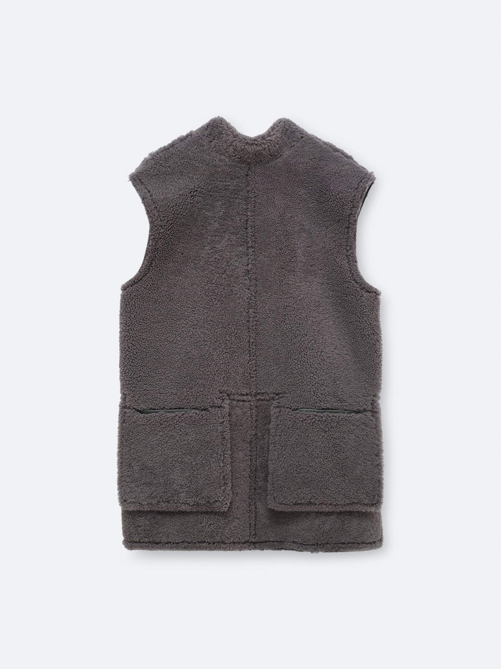 Sleeveless jacket in curly shearling